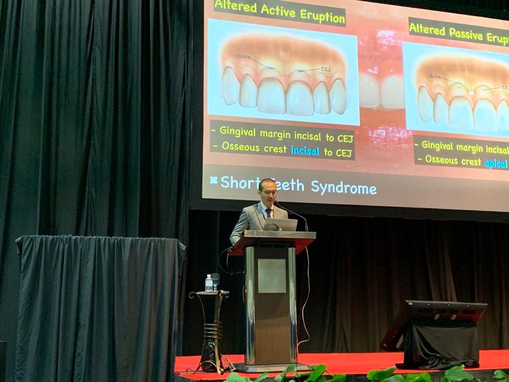 dentist kelvin chua giving a talk about short teeth syndrome