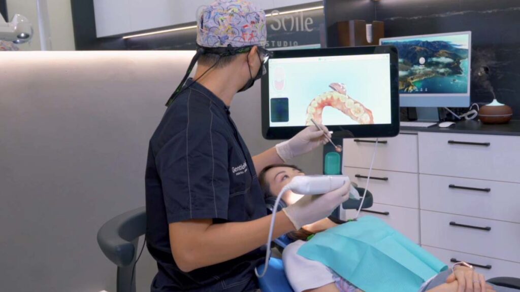 dr kelvin chua dentist doing a scan on a patient