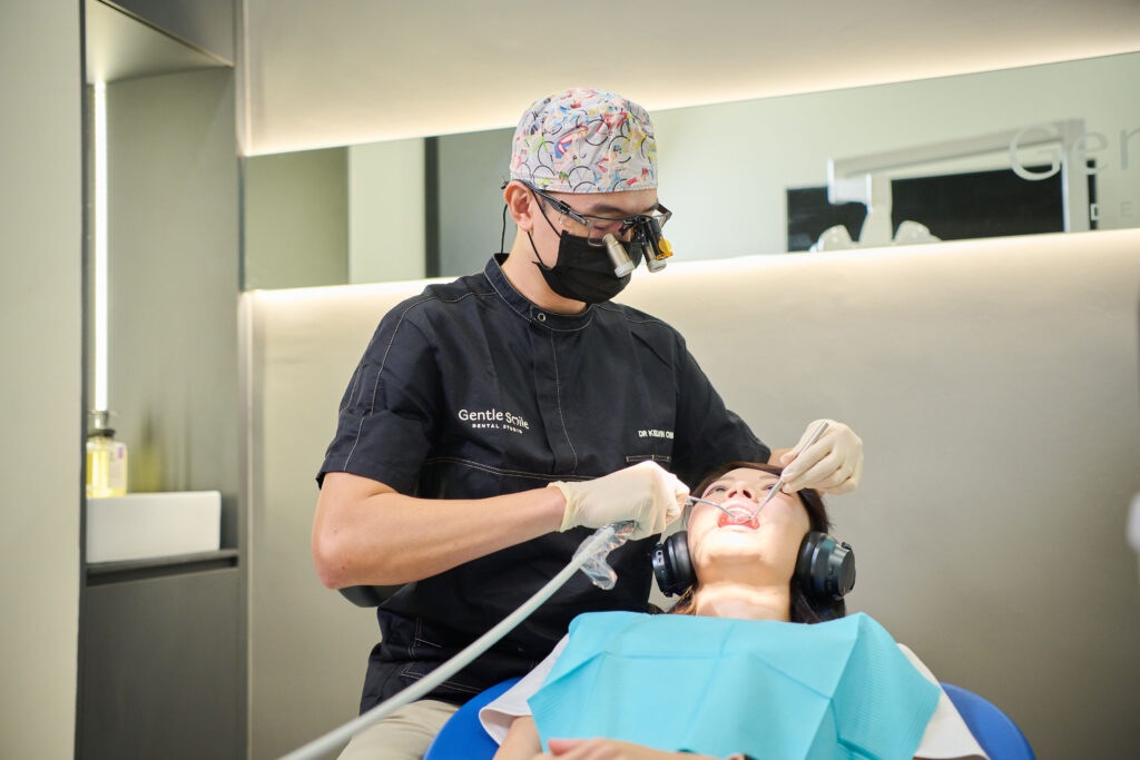 dr kelvin chua dentist giving dental care